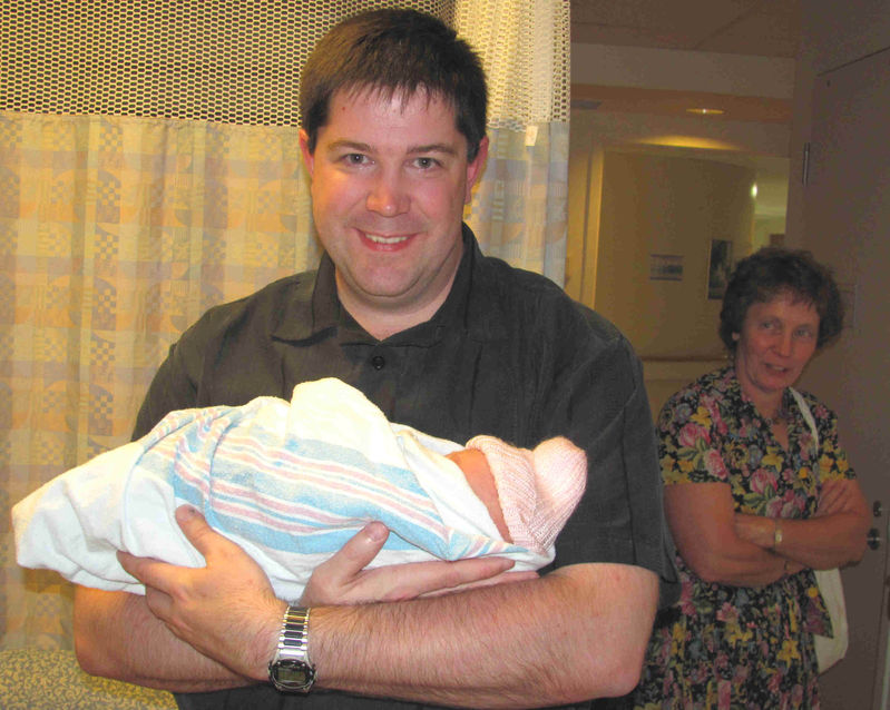 A very proud uncle.  Notice Grandma's expression!
